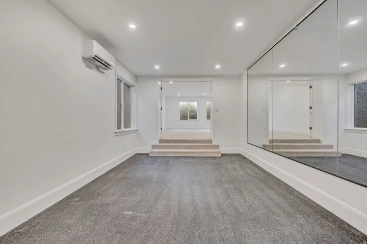 This space can be a home gym (as finished) or an additional bedroom, den or library