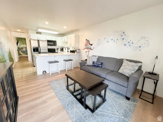 Living area featuring light wood-style flooring and recessed lighting