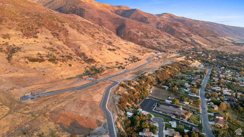 Aerial view of property and surrounding area with a mountainous background