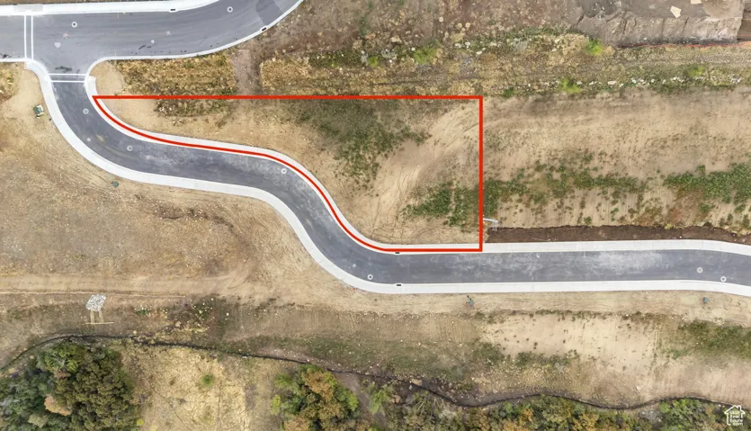 Aerial view of property and surrounding area featuring property parcel outlined