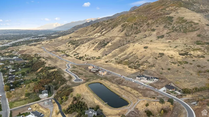 Aerial view of property and surrounding area with a water and mountain view