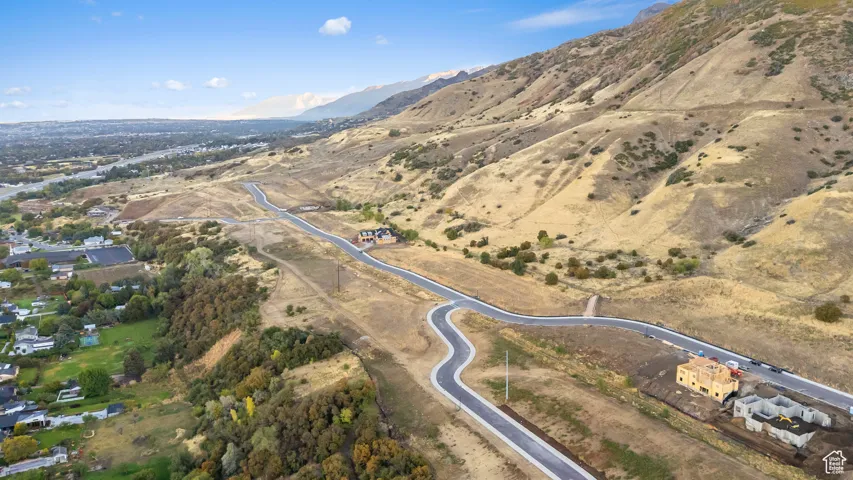 Aerial overview of property's location featuring a mountainous background