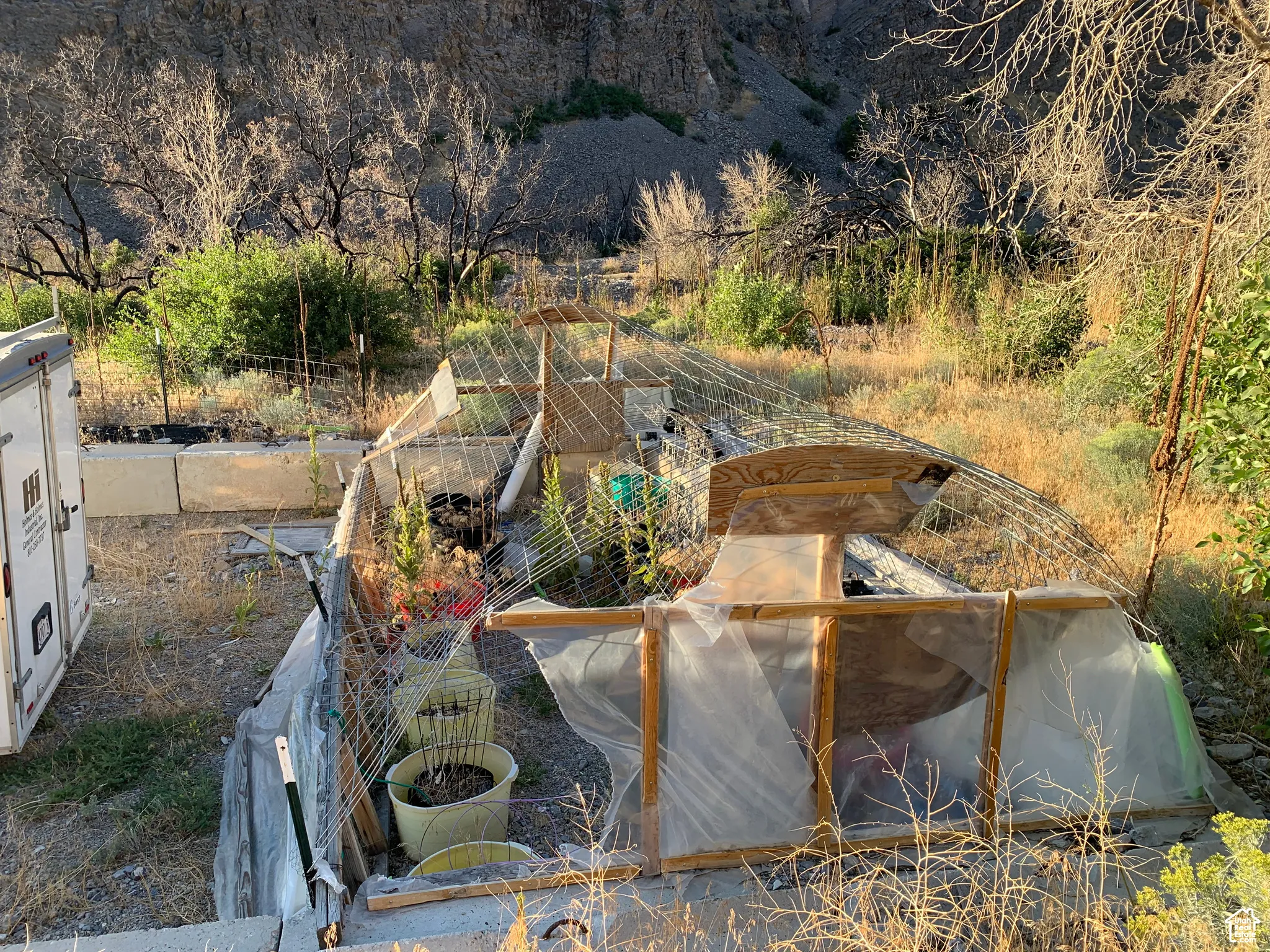 View of swimming pool with a vegetable garden
