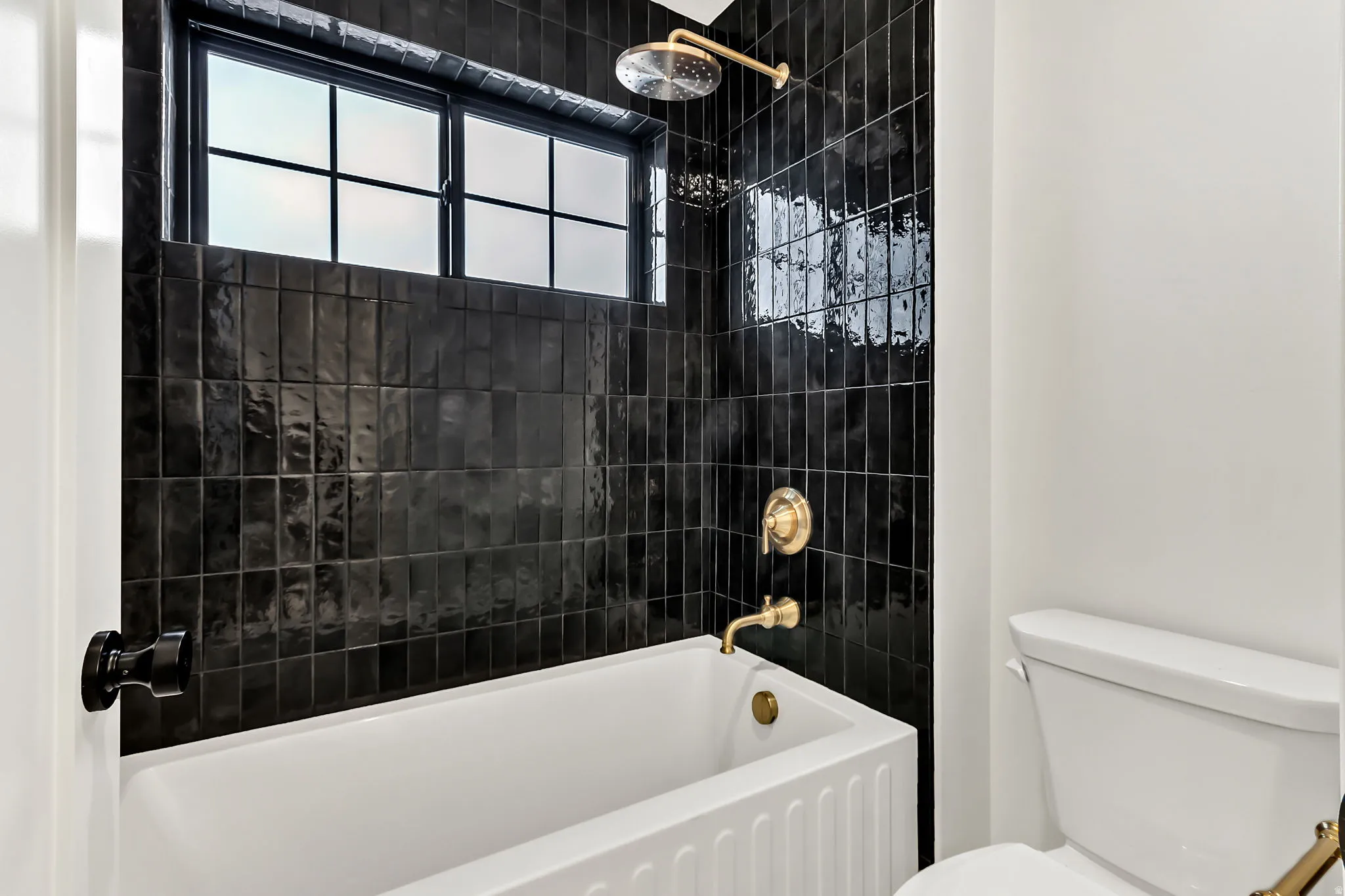 Upstairs bathroom 1 with a tiled shower and full tile surround