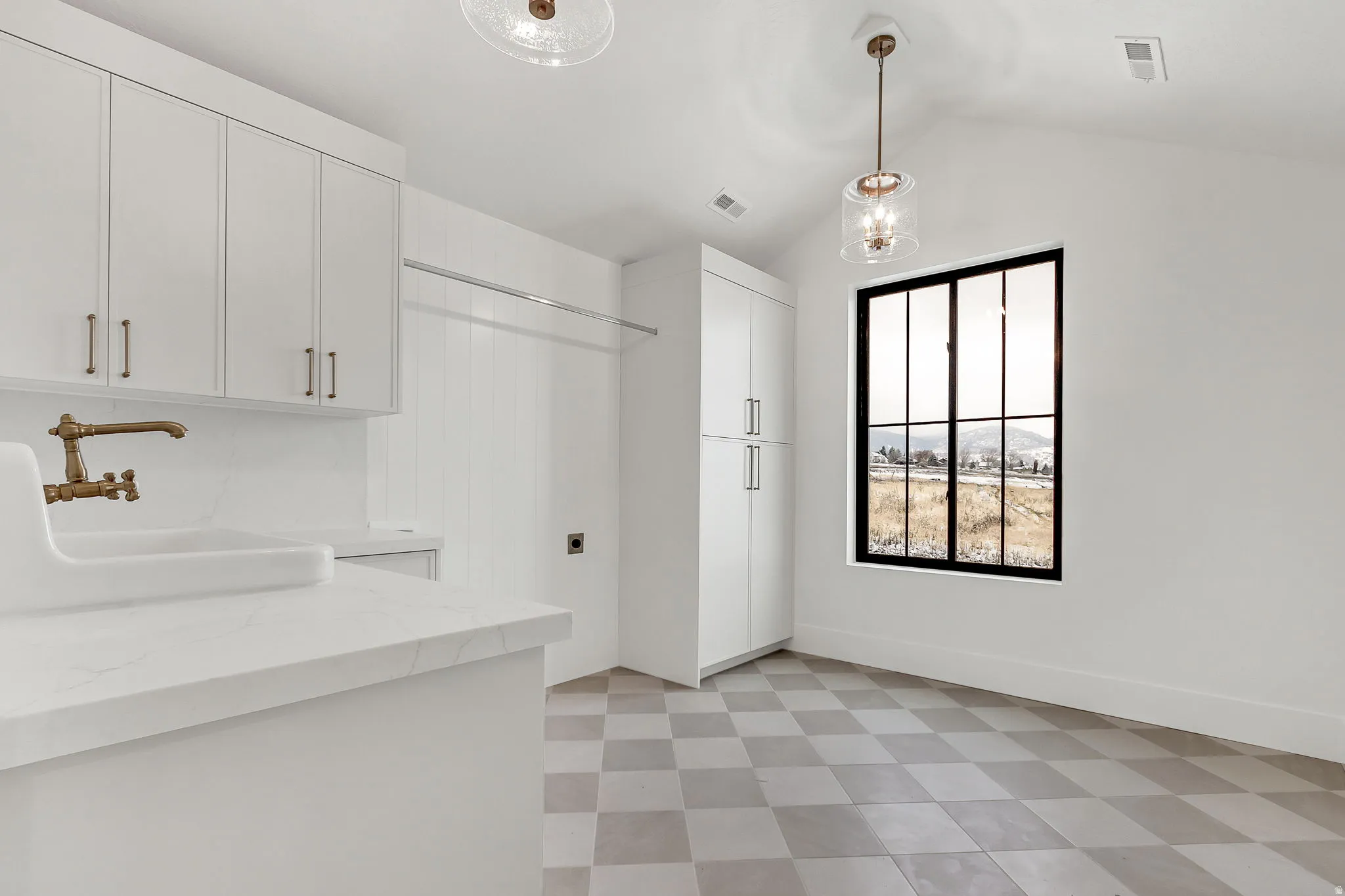 Spacious upstairs laundry room featuring a porcelain sink and slim shaker cabinetry
