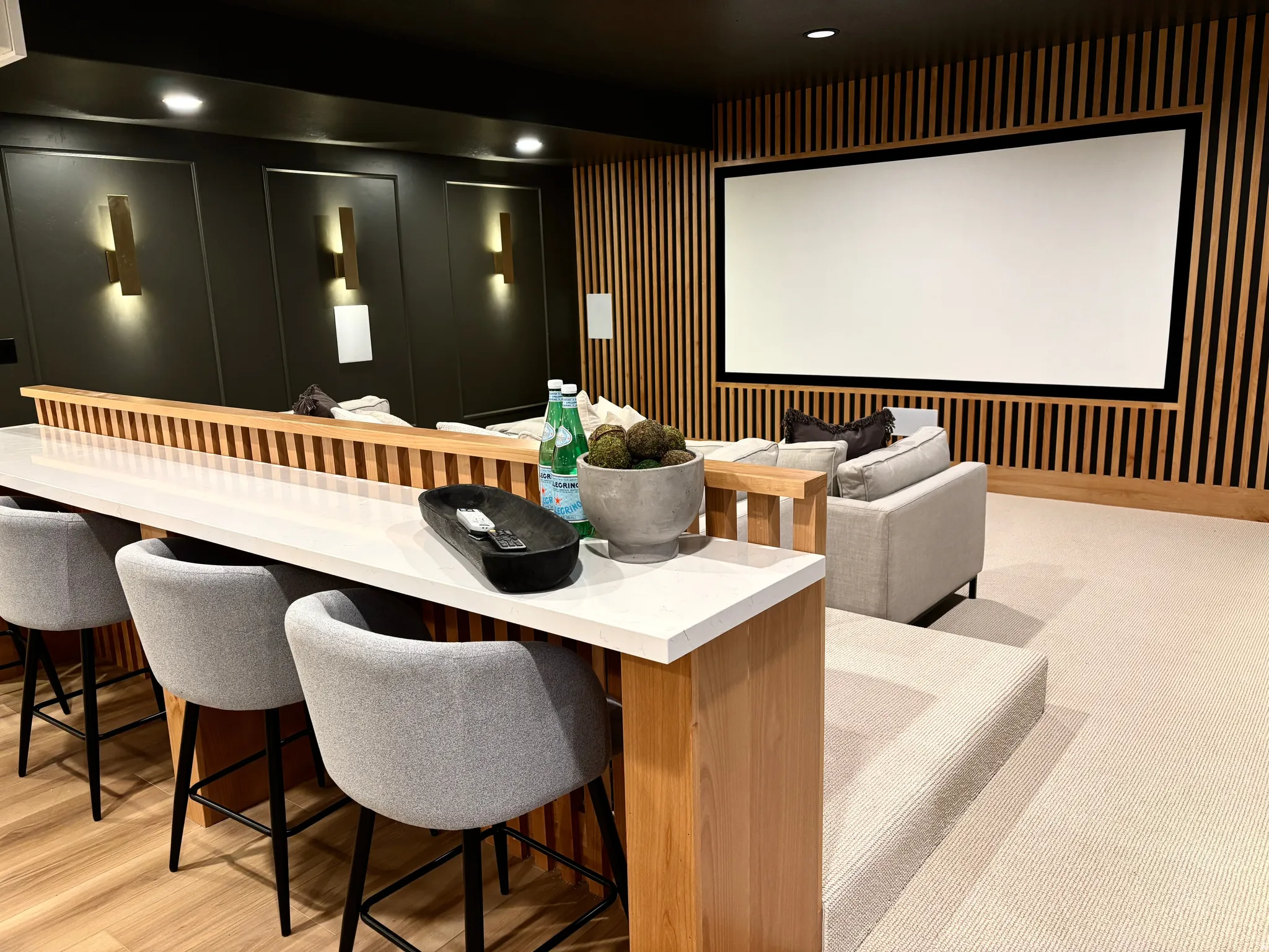 Downstairs open concept cinema/living room featuring a 7.2 professional sound system