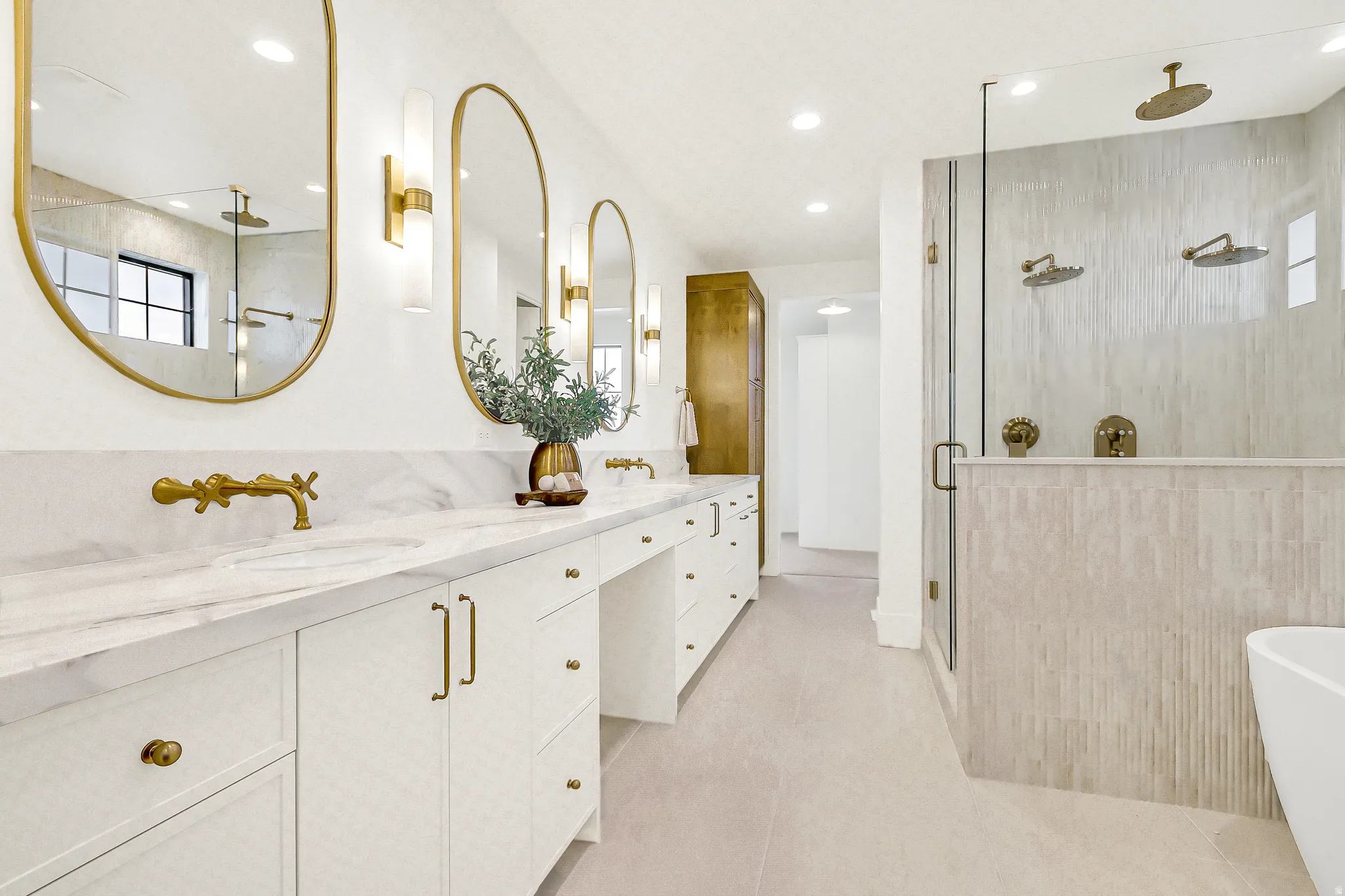 Primary bathroom with a freestanding tub, double vanity, a shower stall, and heated tile  floors