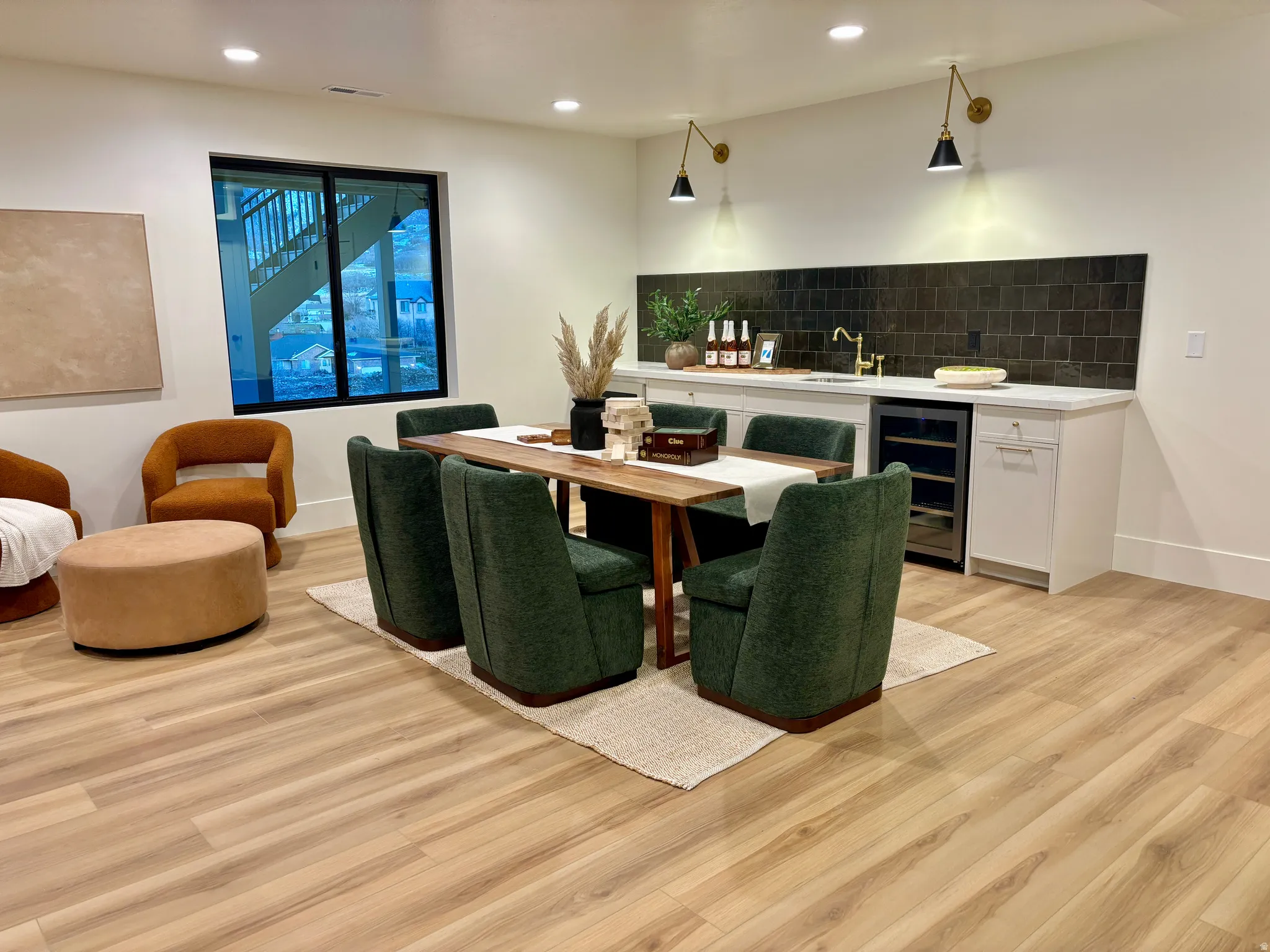 Downstairs open concept recreation room with a wet bar and mini fridge