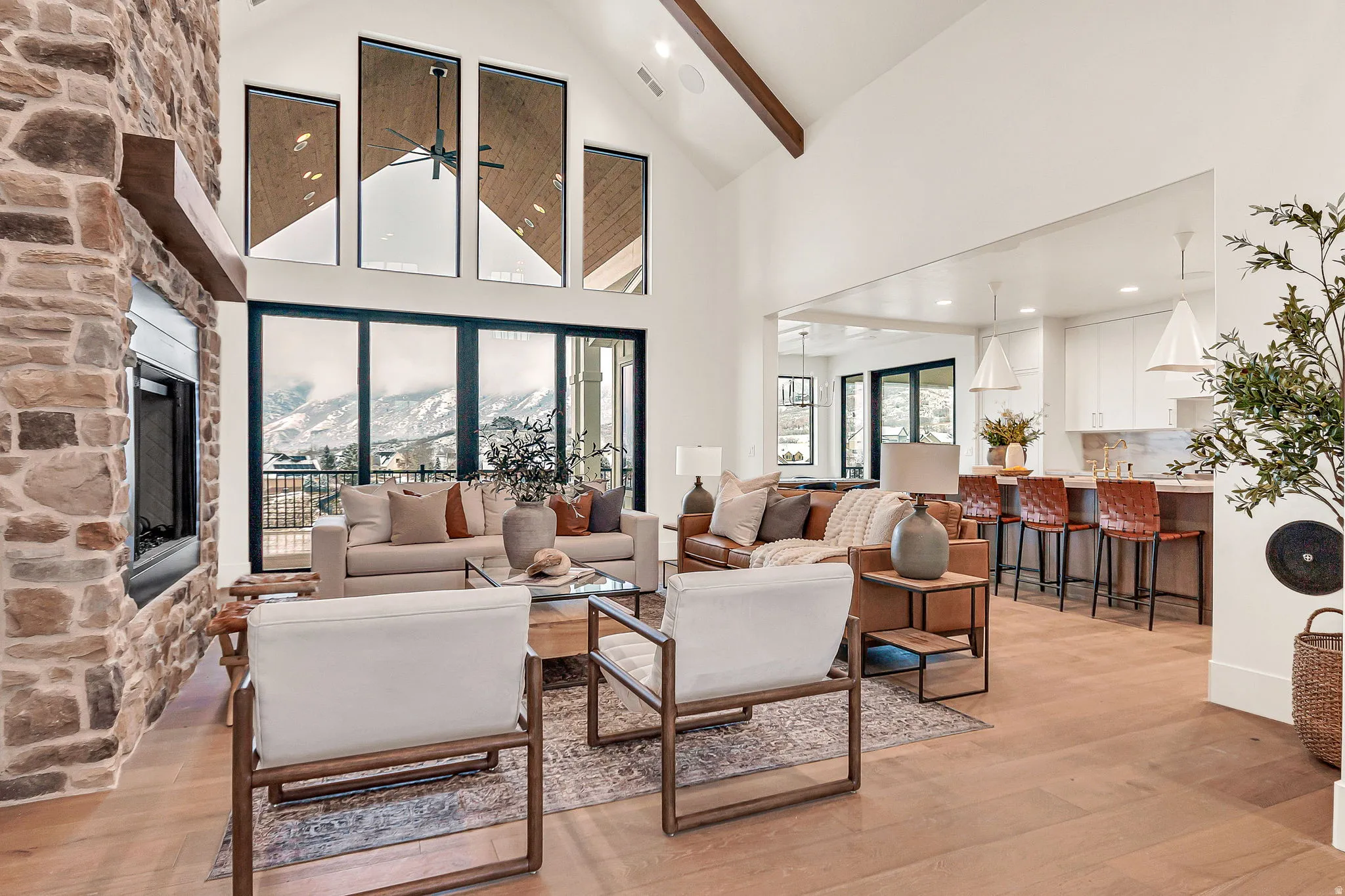 Main level open concept living room with a 60" gas and wood-burning fireplace