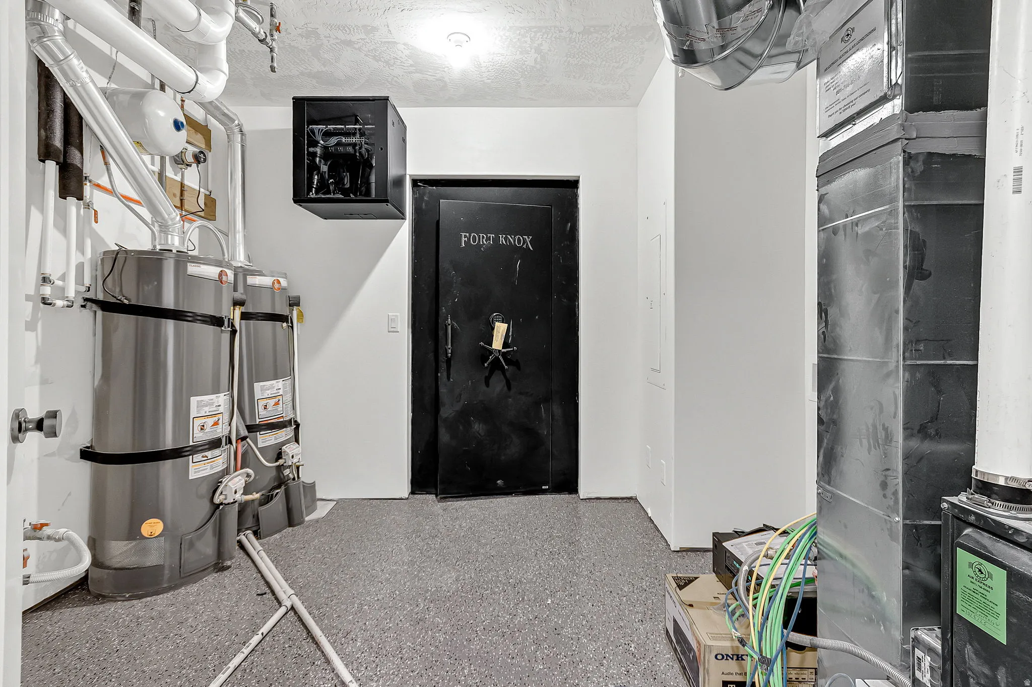 Downstairs utility room with a Fort Knox safe and laundry hookups