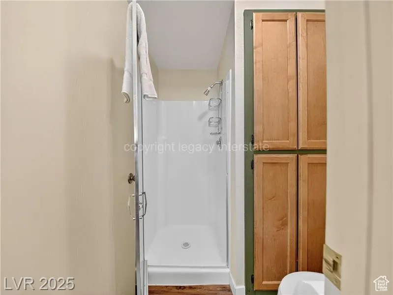 Full bathroom featuring a shower stall