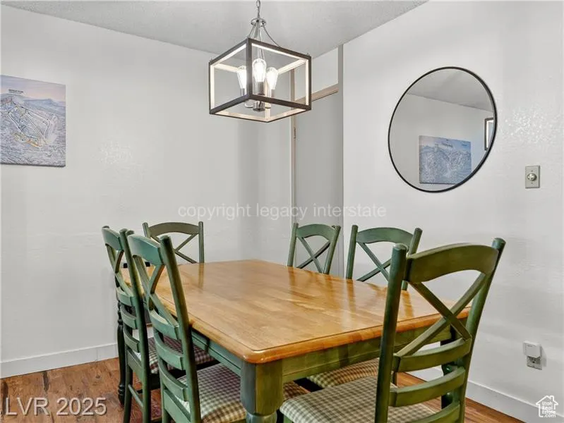 Dining area featuring wood finished floors and a chandelier