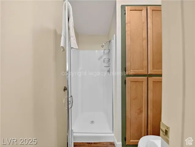 Full bathroom featuring a shower stall