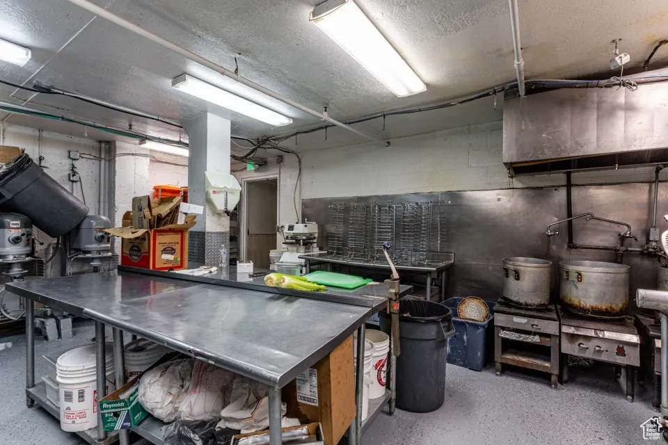 Interior space featuring concrete block wall and a textured ceiling