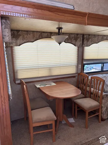 Dining area with a wood-finish oval table and coordinating chairs