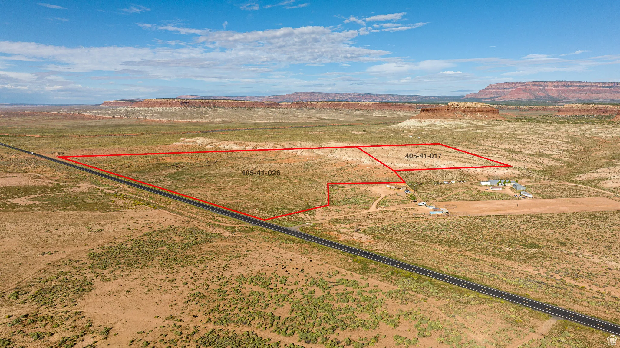 Overview of rural landscape with property parcel outlined and mountains