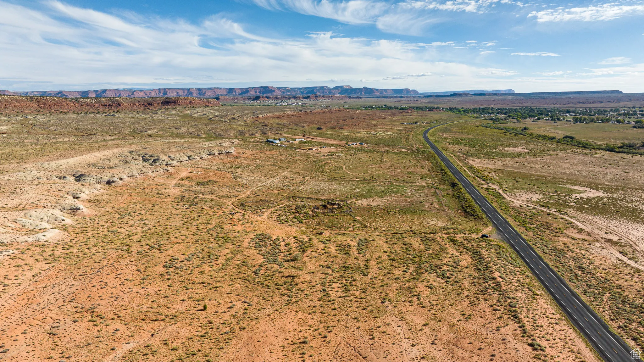 Aerial view of sparsely populated area with a mountain backdrop
