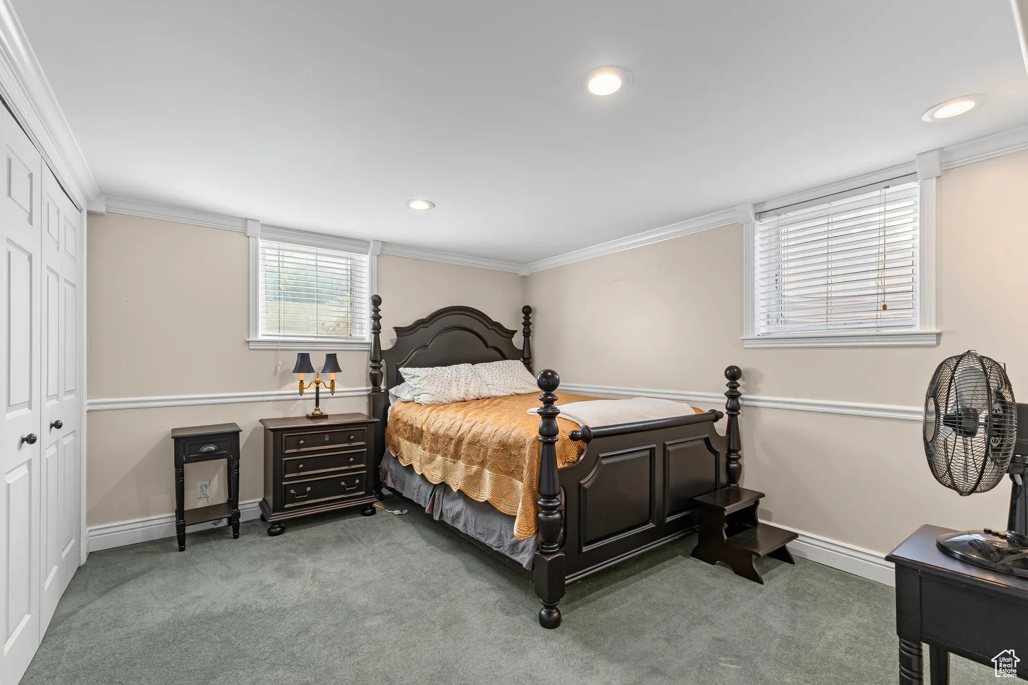 Bedroom with crown molding, light colored carpet, a closet, and recessed lighting