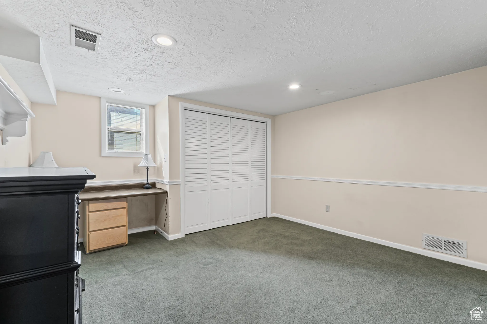 Unfurnished office with carpet, a textured ceiling, and recessed lighting