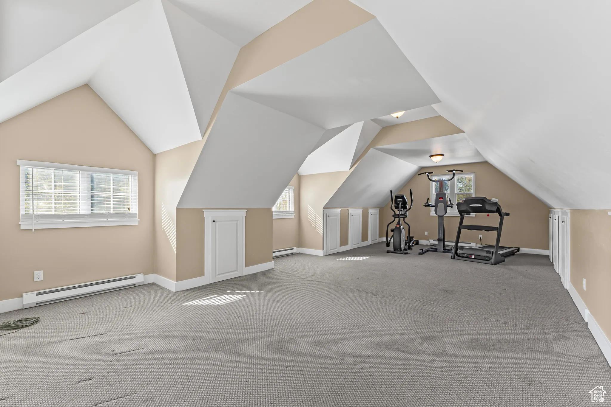 Bonus room with baseboard heating, vaulted ceiling, carpet flooring, and a baseboard radiator
