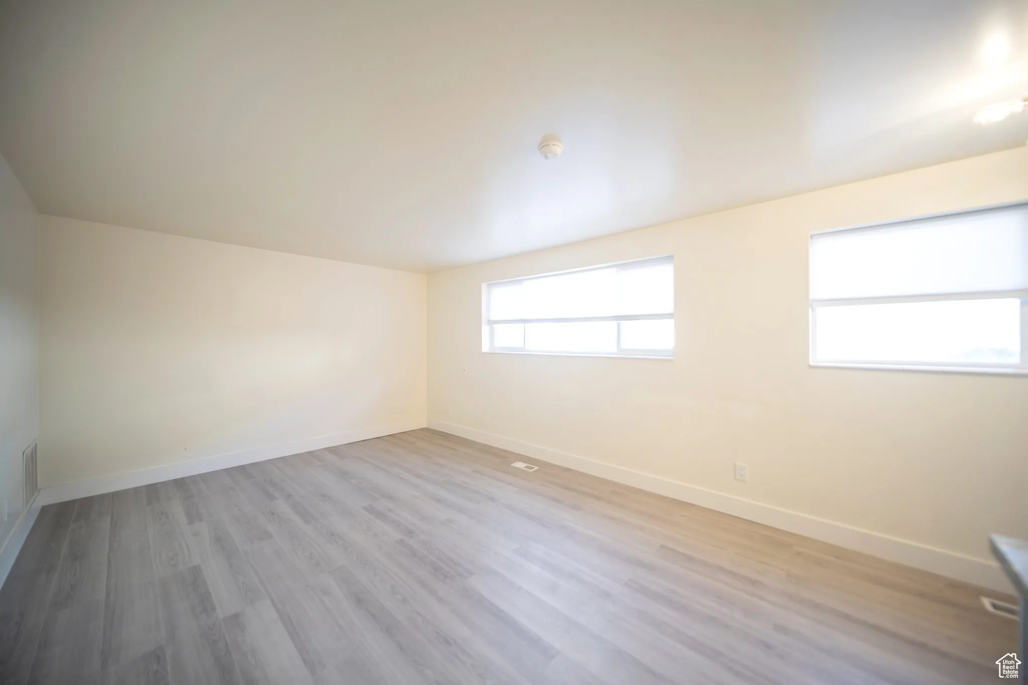 Empty room featuring light wood finished floors and baseboards