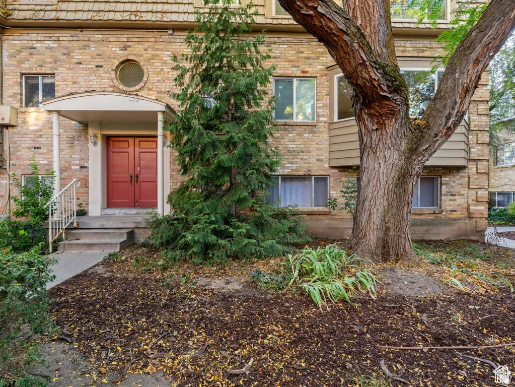 Property entrance featuring brick siding