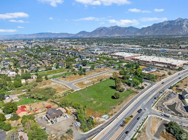 Aerial view of property and surrounding area featuring mountains