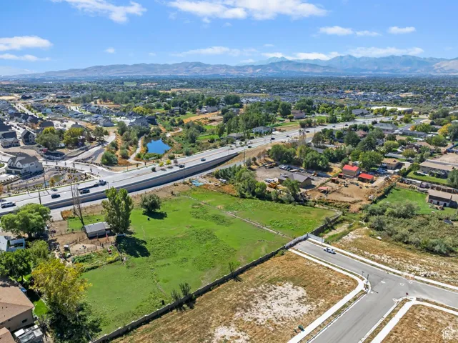 Aerial perspective of suburban area featuring mountains and a main thoroughfare