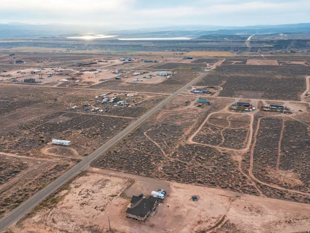 Aerial view of property and surrounding area featuring rural landscape and mountains
