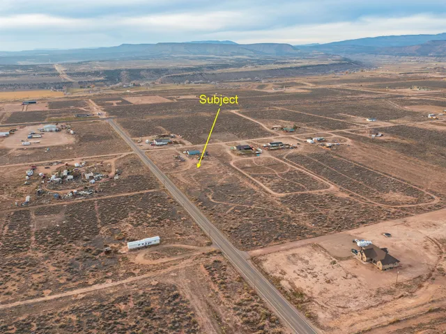 Overview of rural landscape with a mountainous background and property boundaries highlighted