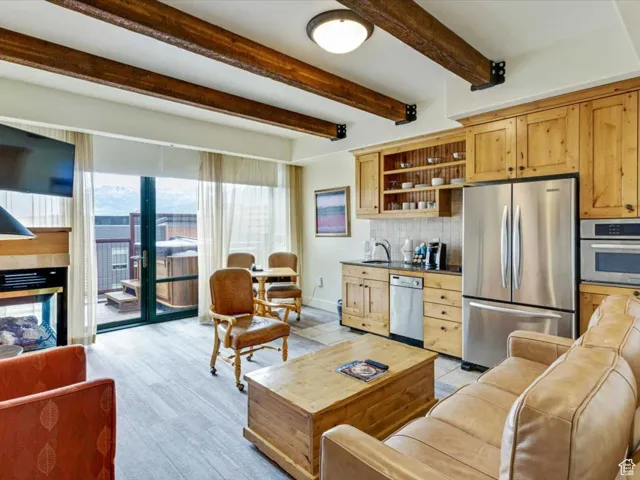 Living room featuring beam ceiling and baseboards