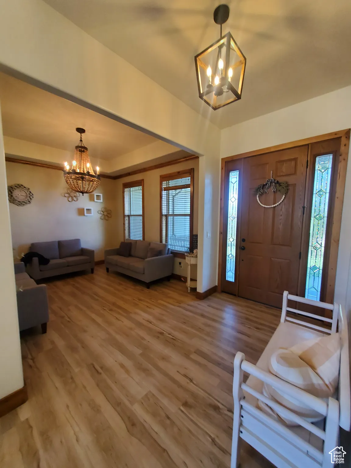 Foyer entrance featuring a chandelier and light wood-style flooring