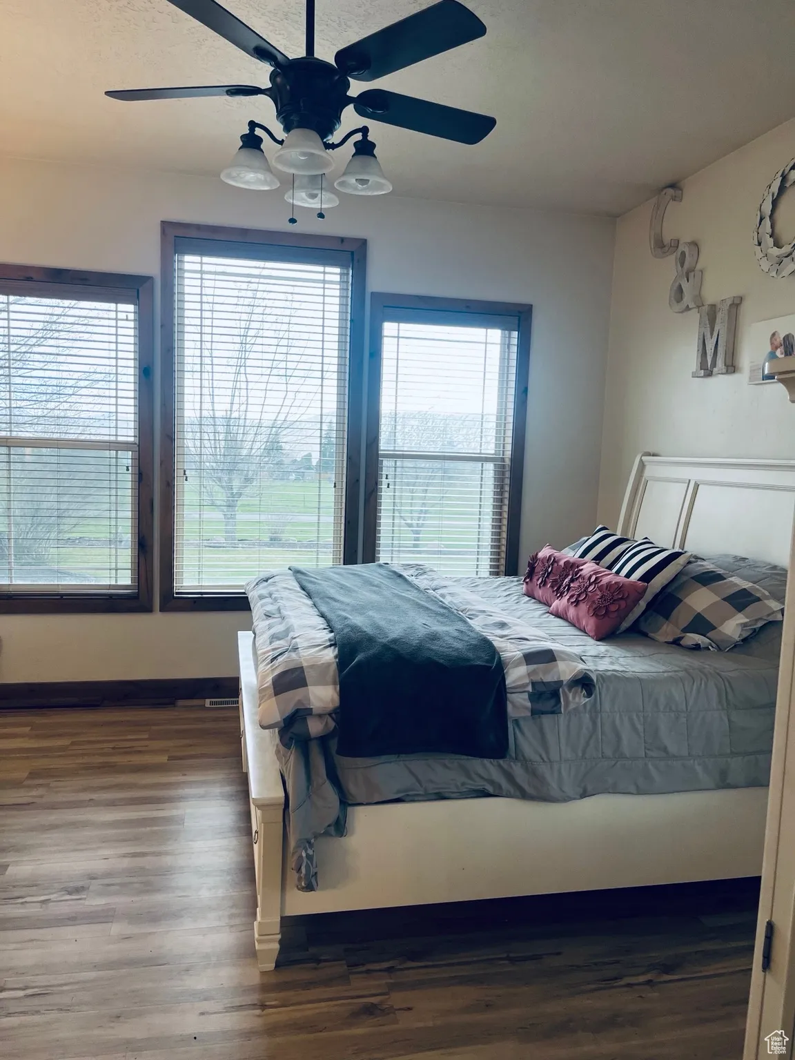 Master Bedroom with dark wood-style floors, a ceiling fan, and a textured ceiling