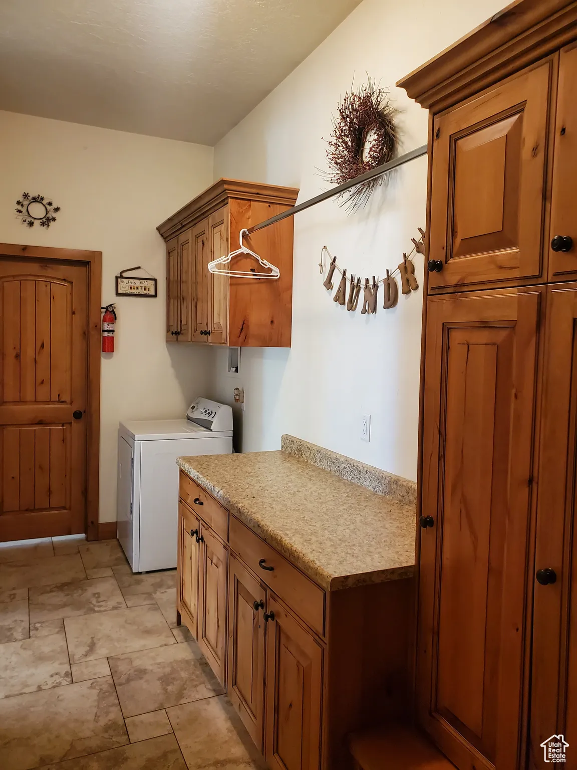 Washroom with cabinet space and washer / dryer