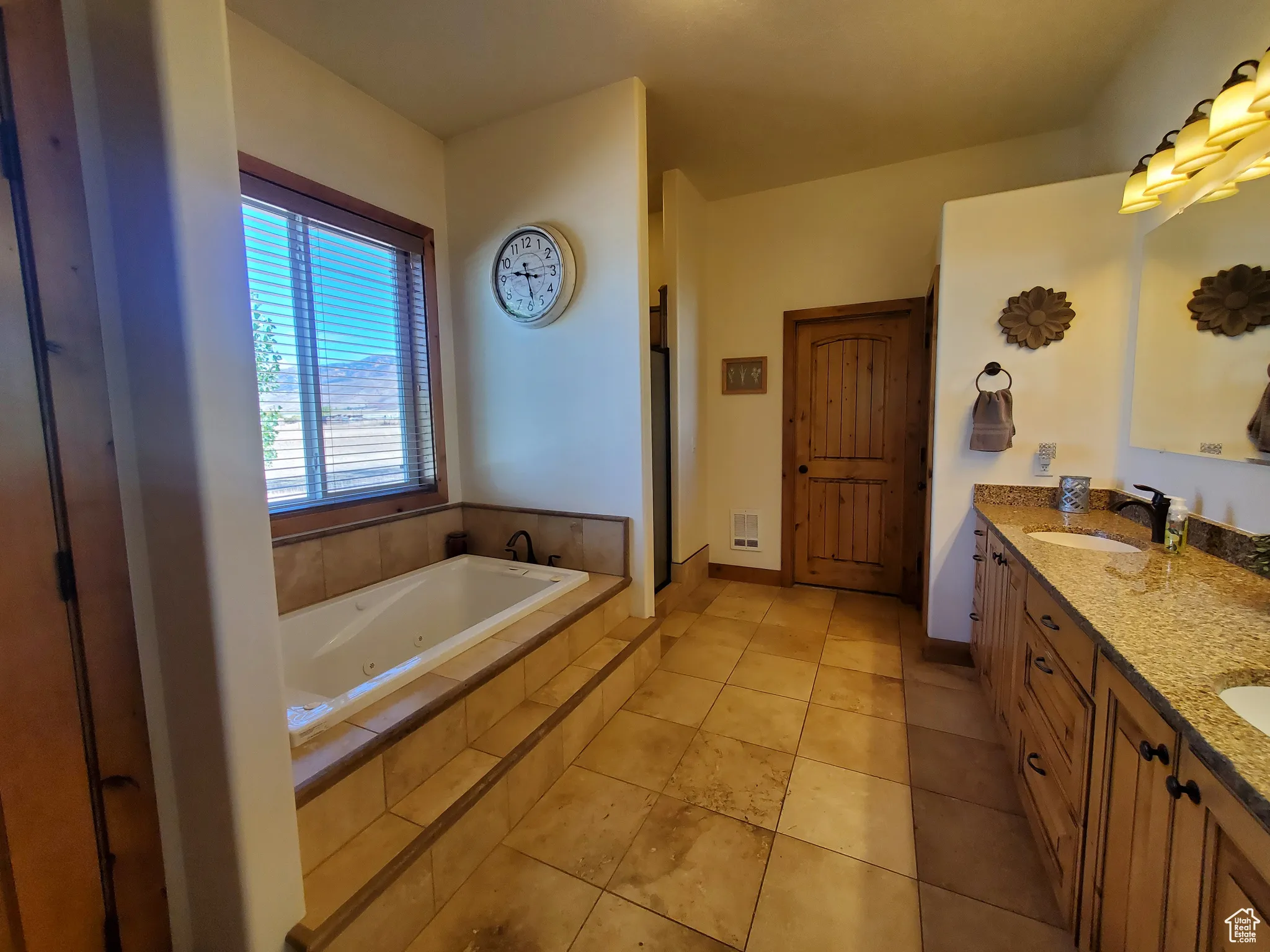 Master Bathroom, Full bath with double vanity, a jetted tub, and light tile patterned floors with walk in shower and toilet room that has its own door.