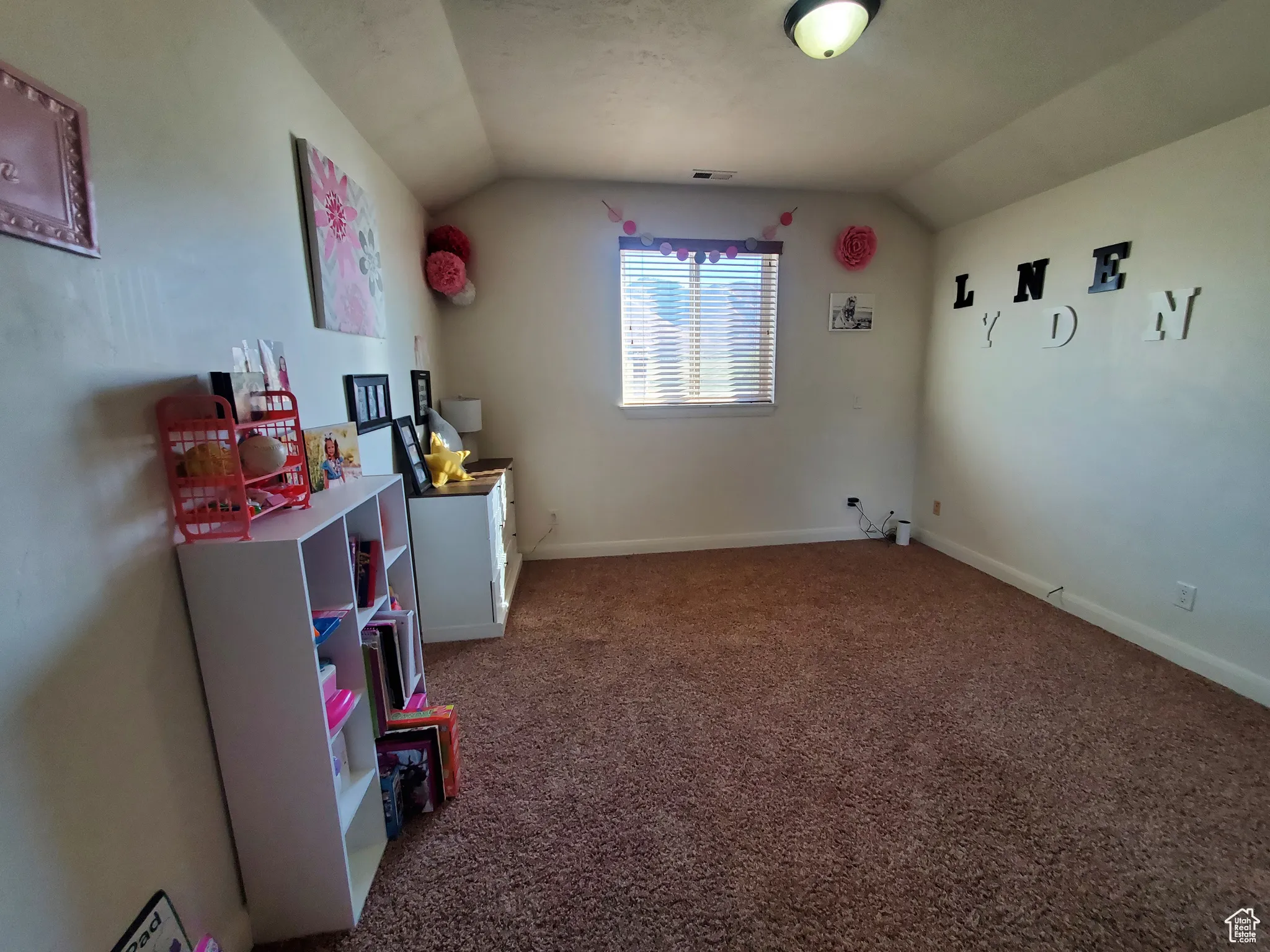 1st. Bedroom upstairs featuring lofted ceiling, dark carpet, and a closet