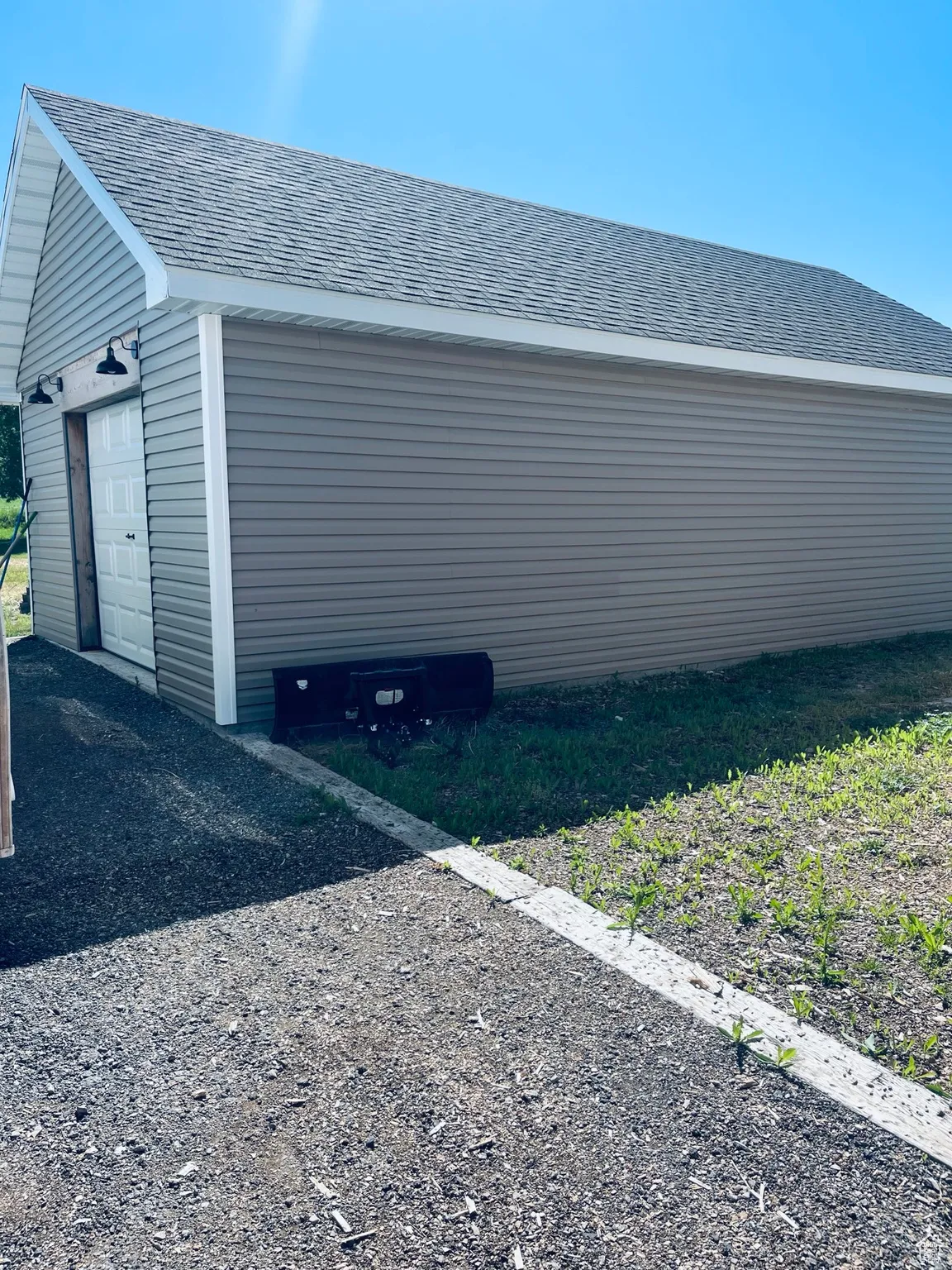 View of garage in back yard this a one car extra deep great for all your yard care equipment or toys