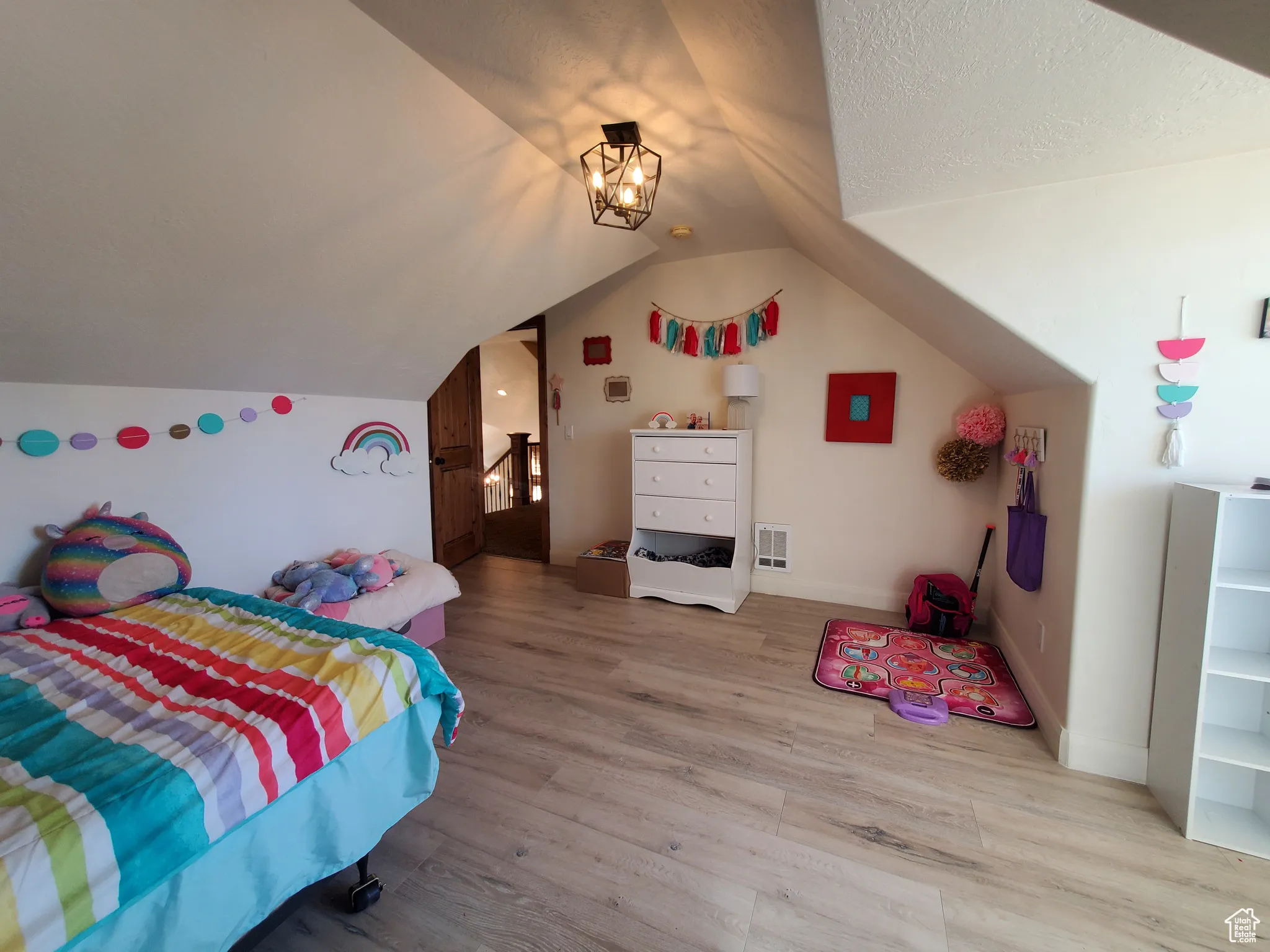 Bedroom #2 upstairs featuring wood finished floors and vaulted ceiling