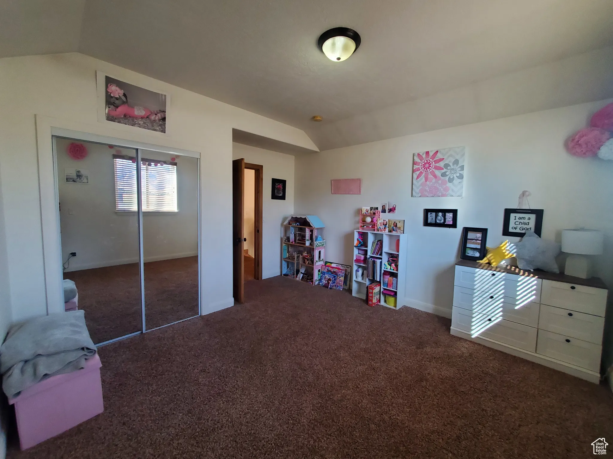 1st. Bedroom upstairs featuring lofted ceiling, dark carpet, and a closet