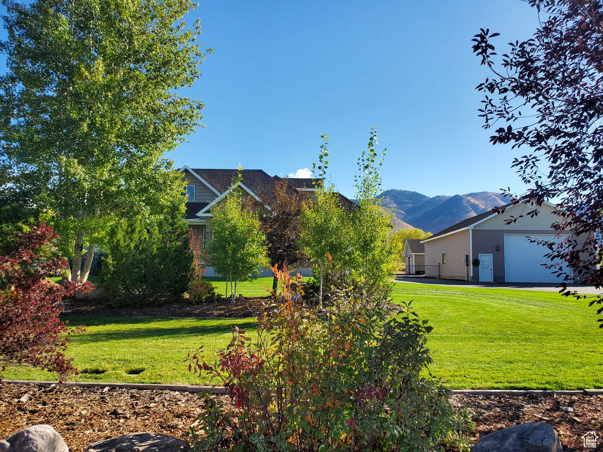 View of green lawn featuring a mountain view