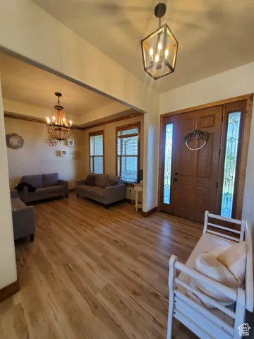 Foyer entrance featuring a chandelier and light wood-style flooring