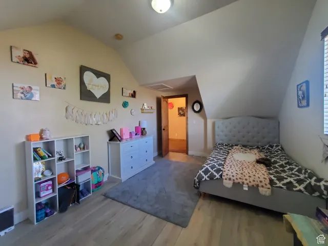 Bedroom #3 upstairs featuring vaulted ceiling and light wood-style flooring