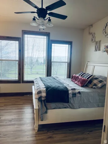Master Bedroom with dark wood-style floors, a ceiling fan, and a textured ceiling