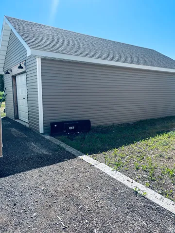 View of garage in back yard this a one car extra deep great for all your yard care equipment or toys