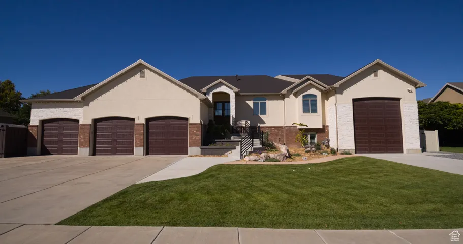 View of front of house featuring driveway, stucco siding, and a garage