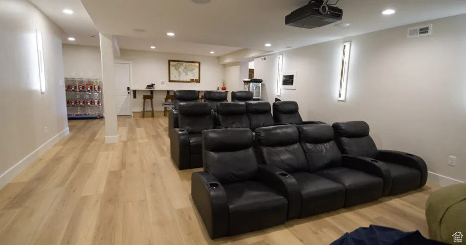 Cinema with recessed lighting and light wood finished floors