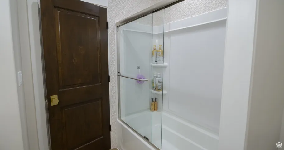 Bathroom with enclosed tub / shower combo