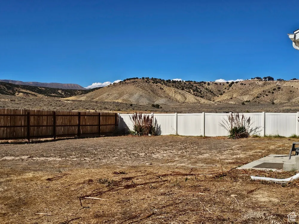 Fenced backyard with a mountain view