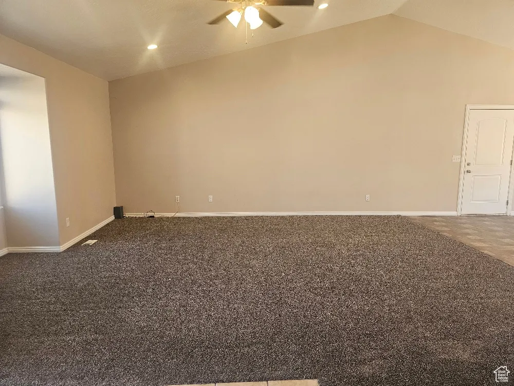 Spare room with ceiling fan, lofted ceiling, recessed lighting, and carpet flooring