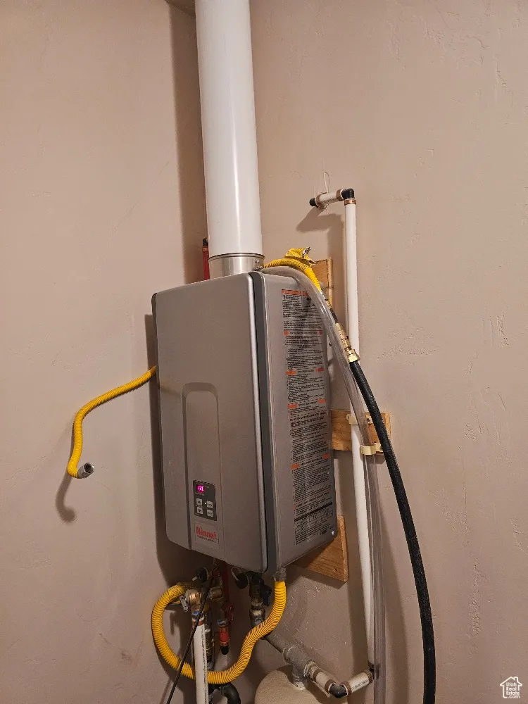 Utility room featuring tankless water heater